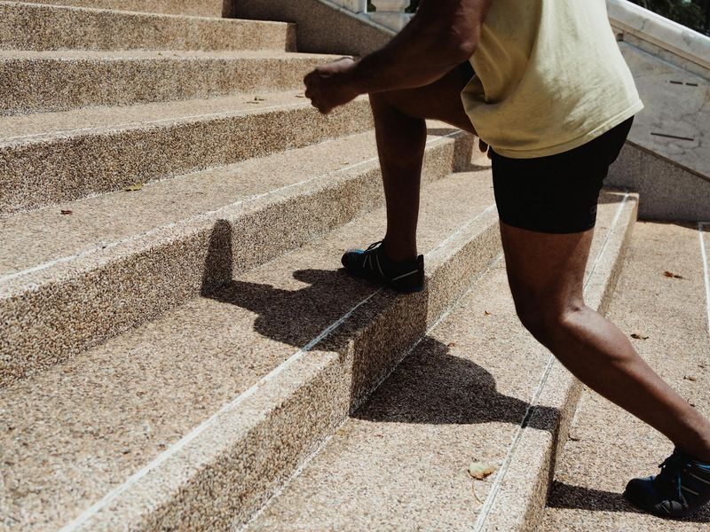 Person doing dynamic cardio steps in a minimal studio